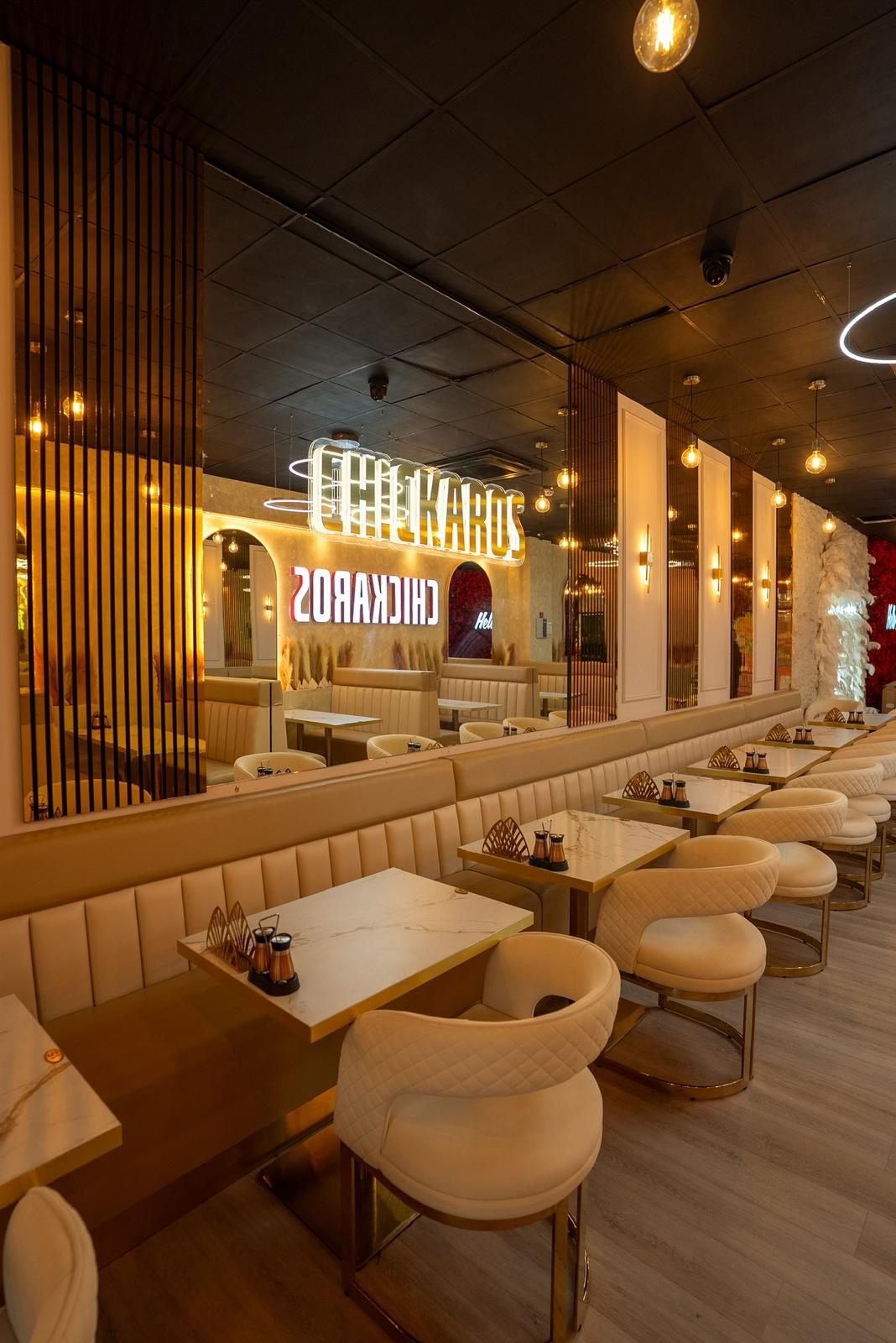 Chickaros neon sign and cream banquettes